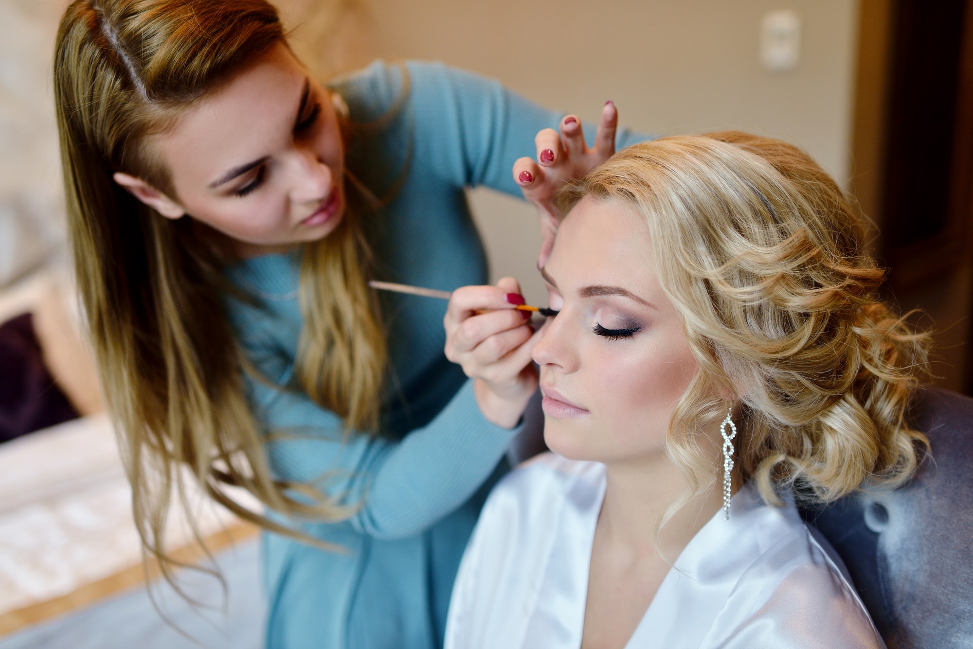 wedding makeup artist making a make up for bride
